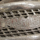 A close up photo of a rusty Triumph name badge.